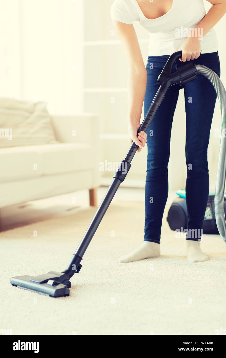 close up of woman with vacuum cleaner at home Stock Photo