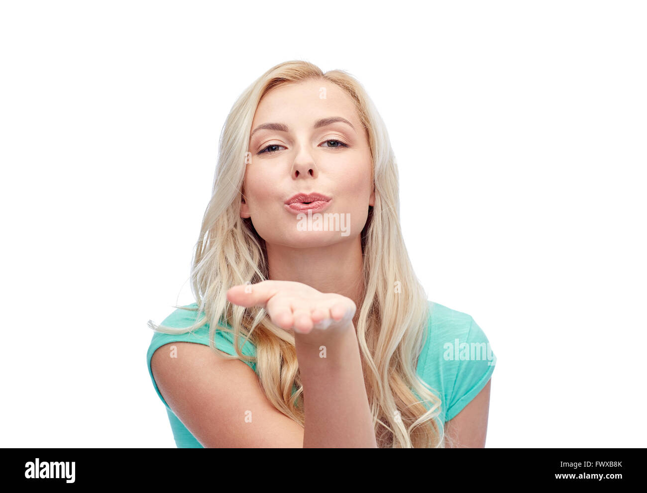 smiling young woman or teen girl sending blow kiss Stock Photo