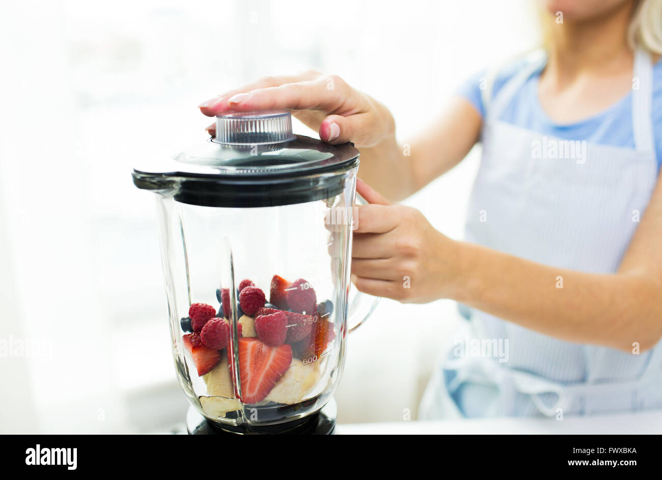 close up of woman hand pouring milk to blender Stock Photo - Alamy