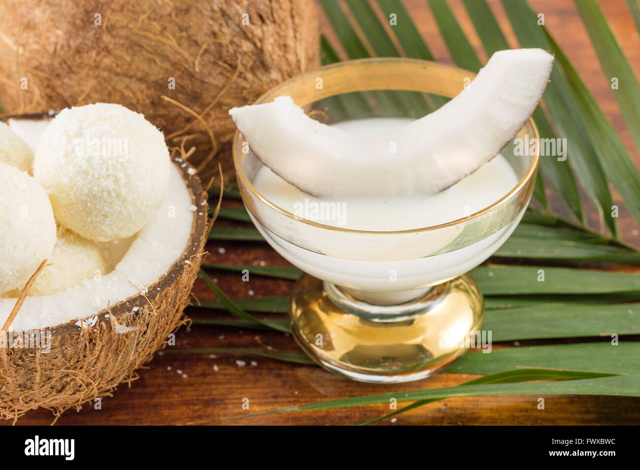 Coconut liqueur in glass served with fresh coconut Stock Photo Alamy