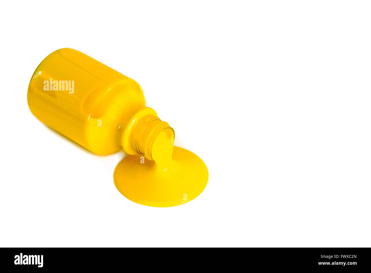 Yellow paint pouring from a bottle isolated on white Stock Photo