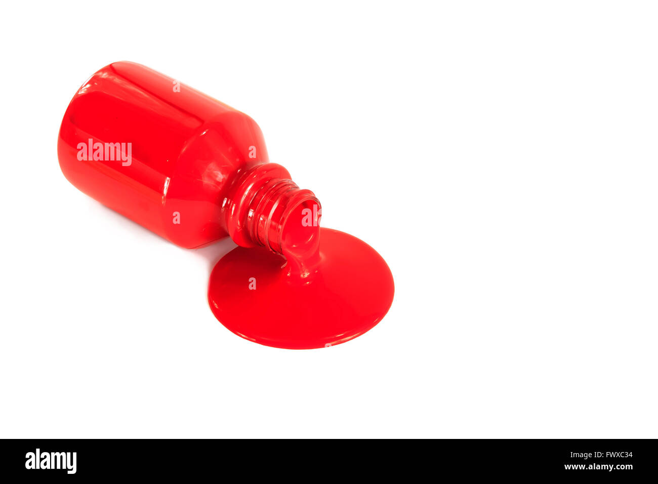 Red paint pouring from a bottle isolated on white Stock Photo