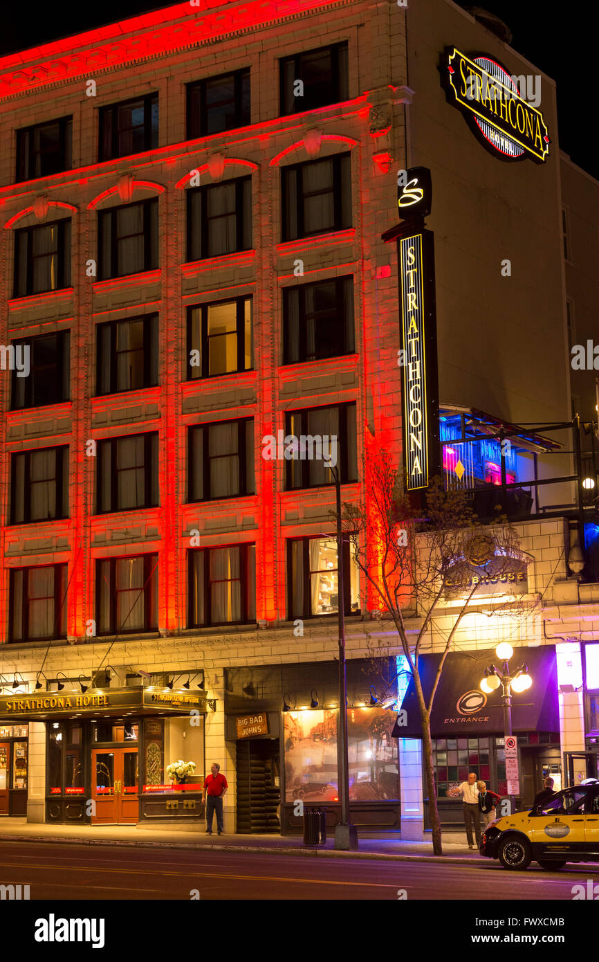 Taxicab waiting for customer outside Strathcona hotel and pub  at night-Victoria, British Columbia, Canada. Stock Photo