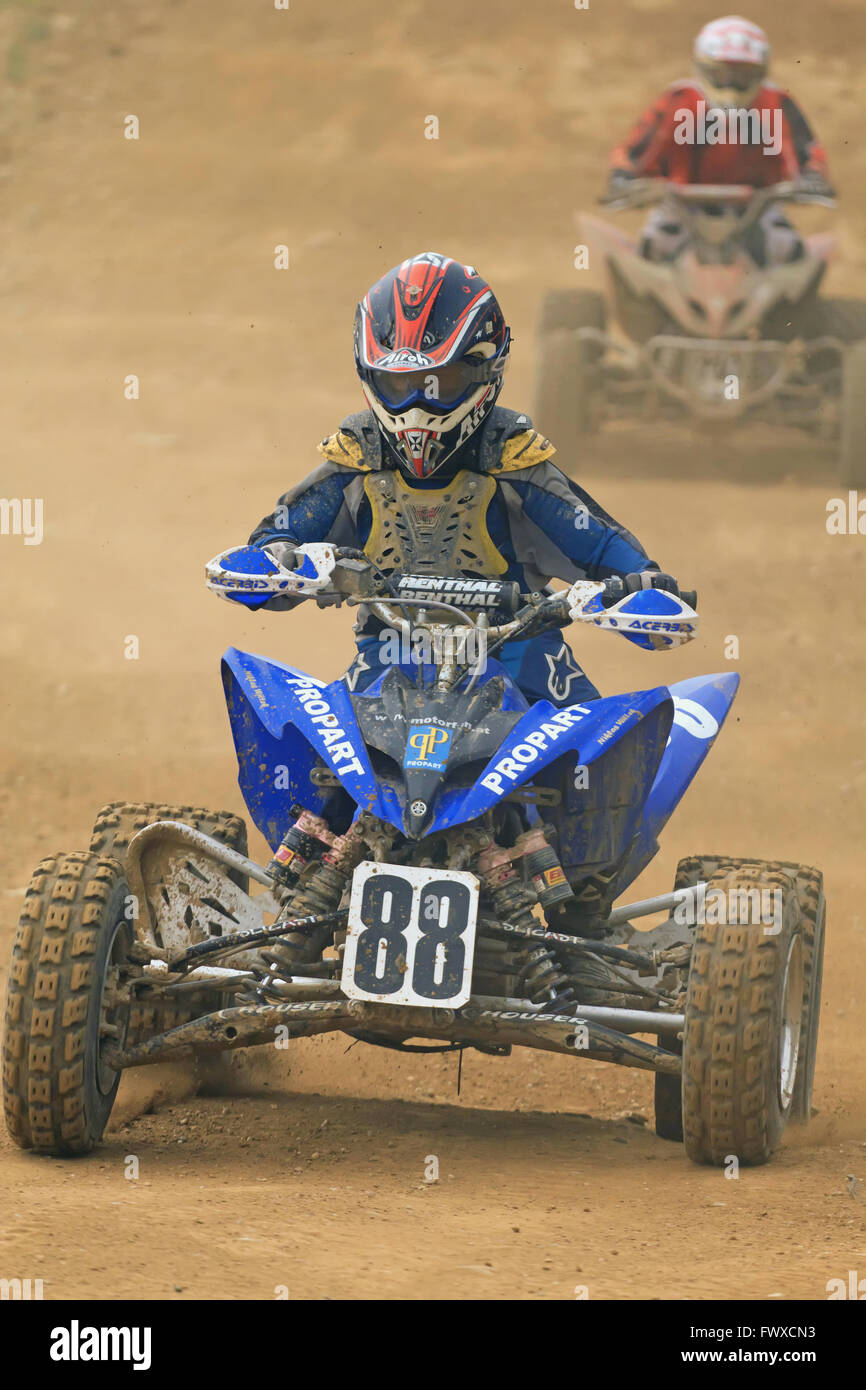 Young boy is riding a blue quad motorbike in the race Stock Photo - Alamy