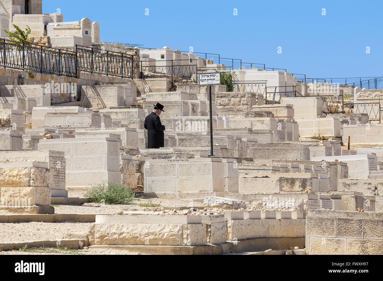 Religious Jew prays at the old Jewish cemetery on  Mount of Olives in Jerusalem, Israel. Stock Photo