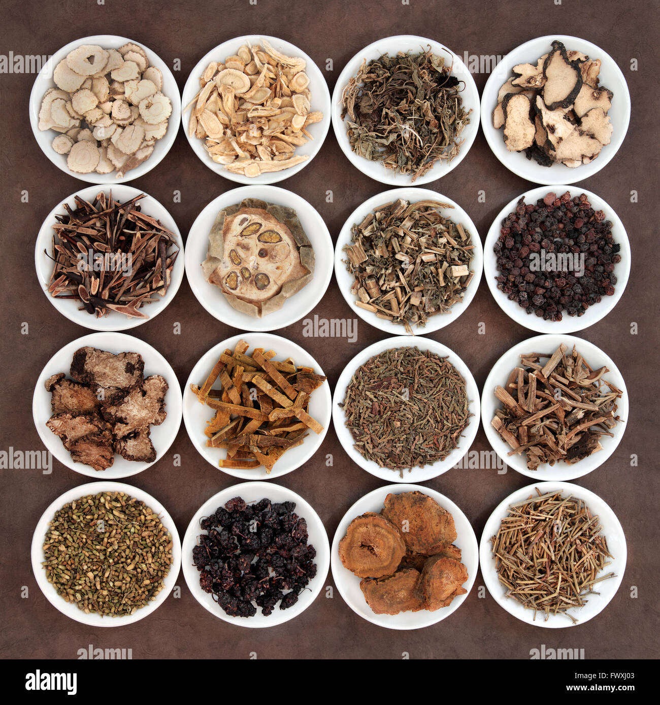 Chinese herbal medicine selection in porcelain bowls. Stock Photo