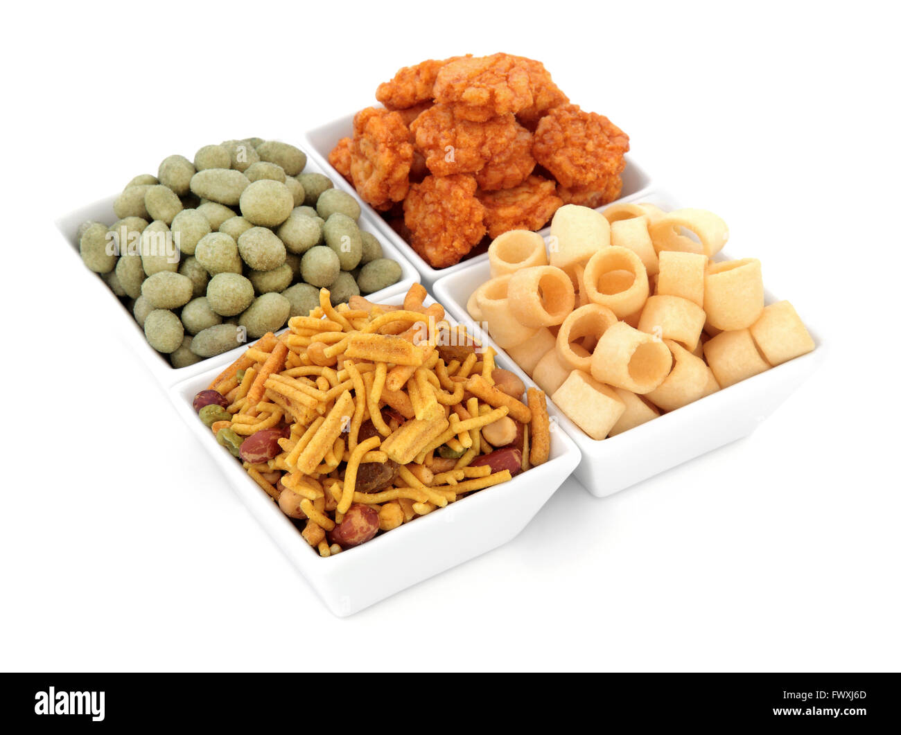 Savory snack party food selection in square porcelain bowls over white background. Stock Photo