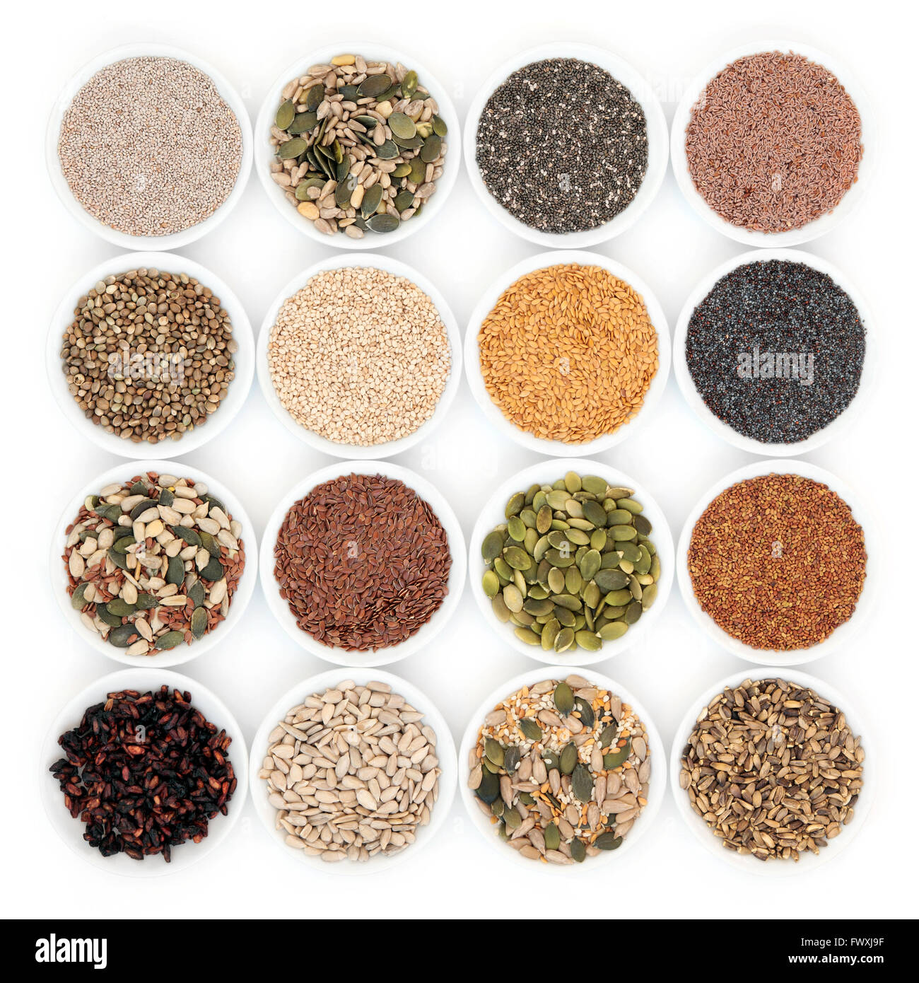 Seed and nut health food in porcelain bowls over white background Stock Photo Alamy