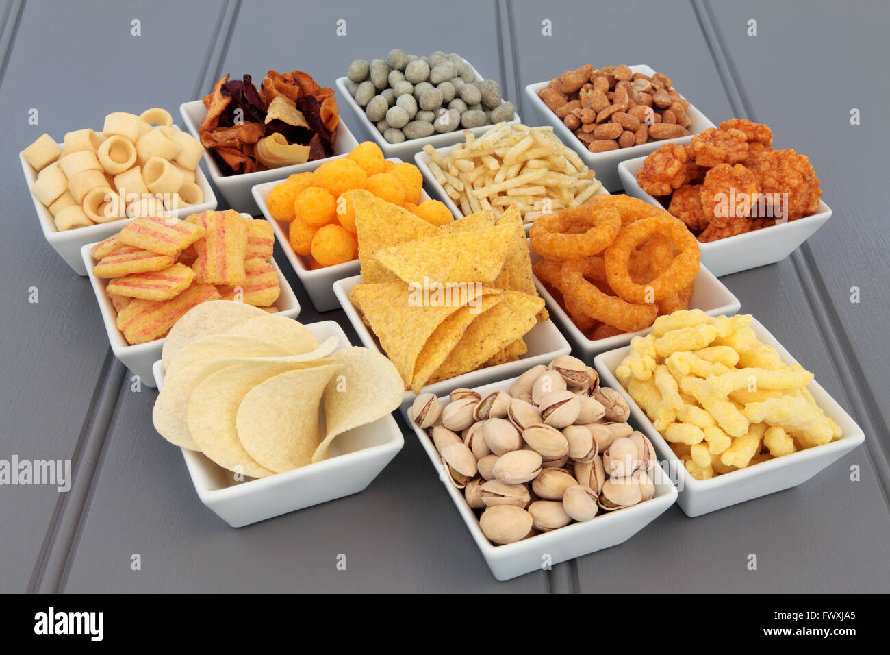 Savory snack party food selection in square porcelain bowls. Stock Photo