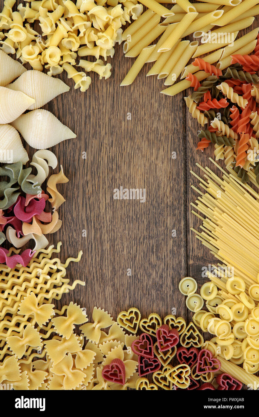 Italian pasta food selection forming an abstract border over old oak  background Stock Photo - Alamy