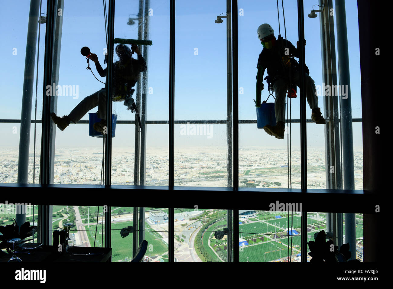 QATAR, Doha, sportspark at Khalifa International Stadium for FIFA world cup 2022, Filipino migrant worker work as window cleaner at Aspire tower, sport park Aspire Academy for Sports Excellence is also training camp of german soccer club FC Bayern , FC Bavaria Stock Photo