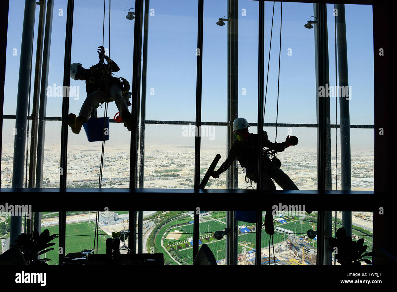 QATAR, Doha, sportspark at Khalifa International Stadium for FIFA world cup 2022, Filipino migrant worker work as window cleaner at Aspire tower, sport park Aspire Academy for Sports Excellence is also training camp of german soccer club FC Bayern , FC Bavaria Stock Photo
