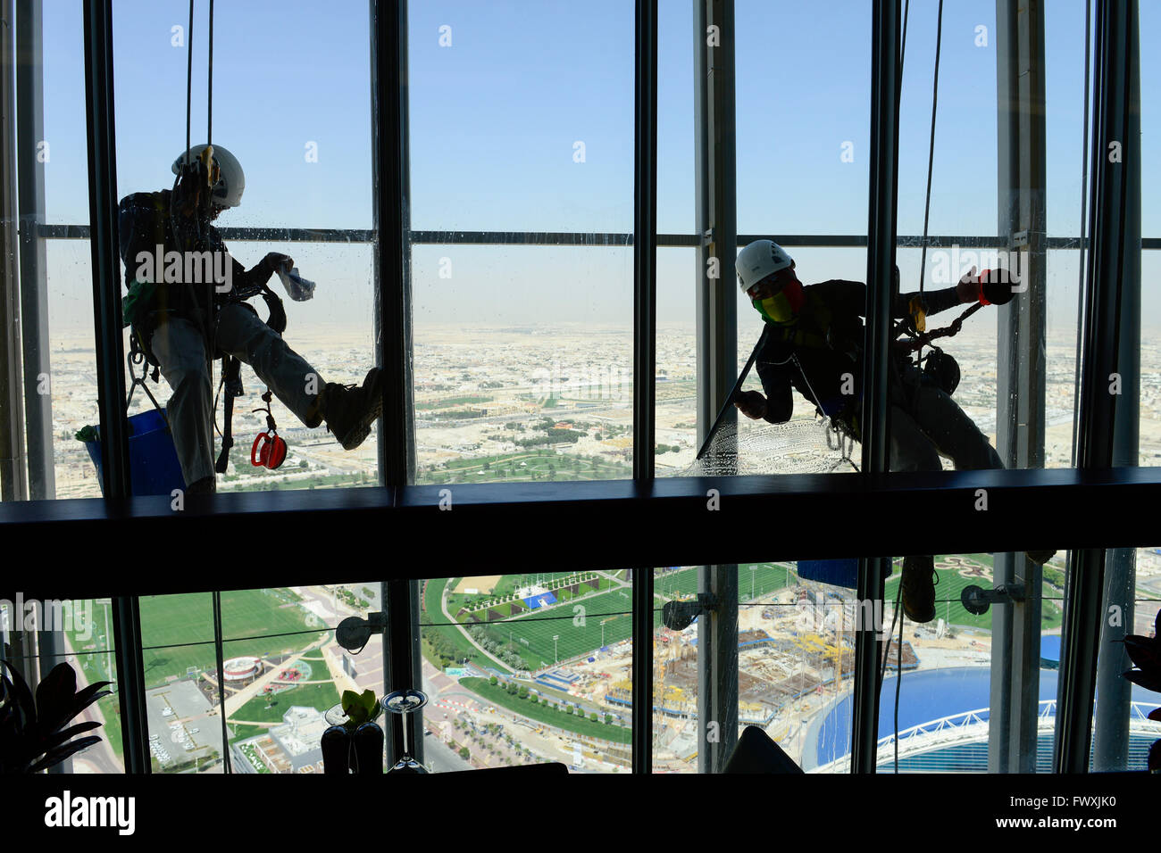QATAR, Doha, sportspark at Khalifa International Stadium for FIFA world cup 2022, Filipino migrant worker work as window cleaner at Aspire tower, sport park Aspire Academy for Sports Excellence is also training camp of german soccer club FC Bayern , FC Bavaria Stock Photo