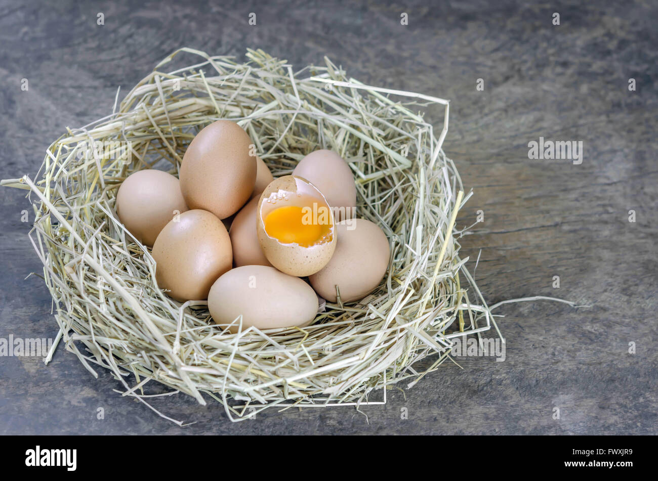 still life brown eggs in nest on wooden background Stock Photo - Alamy