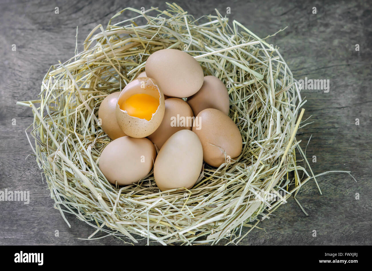 still life brown eggs in nest on wooden background Stock Photo - Alamy