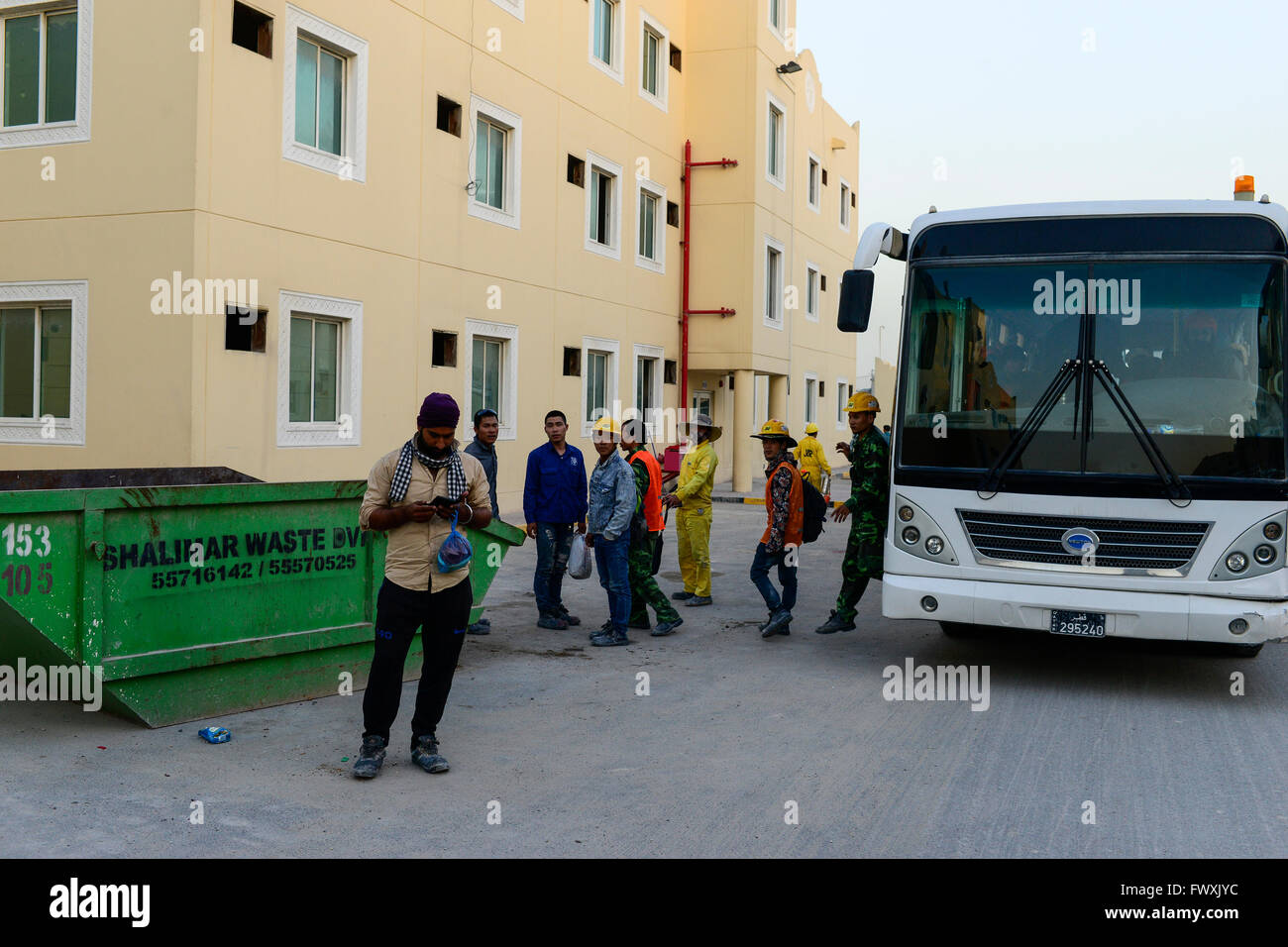 QATAR, Doha, industrial complex, housing camp for foreign migrant worker outside the city, the contract worker work on construction sites for the FIFA soccer World Cup 2022, bus transfer from work to camp Stock Photo