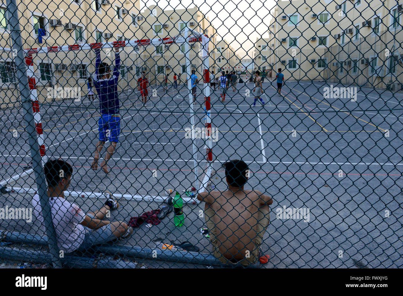 QATAR, Doha, industrial complex, housing camp for migrant worker outside  the city, sports place, worker from Vietnam and Philippines play football  at sports ground Stock Photo - Alamy