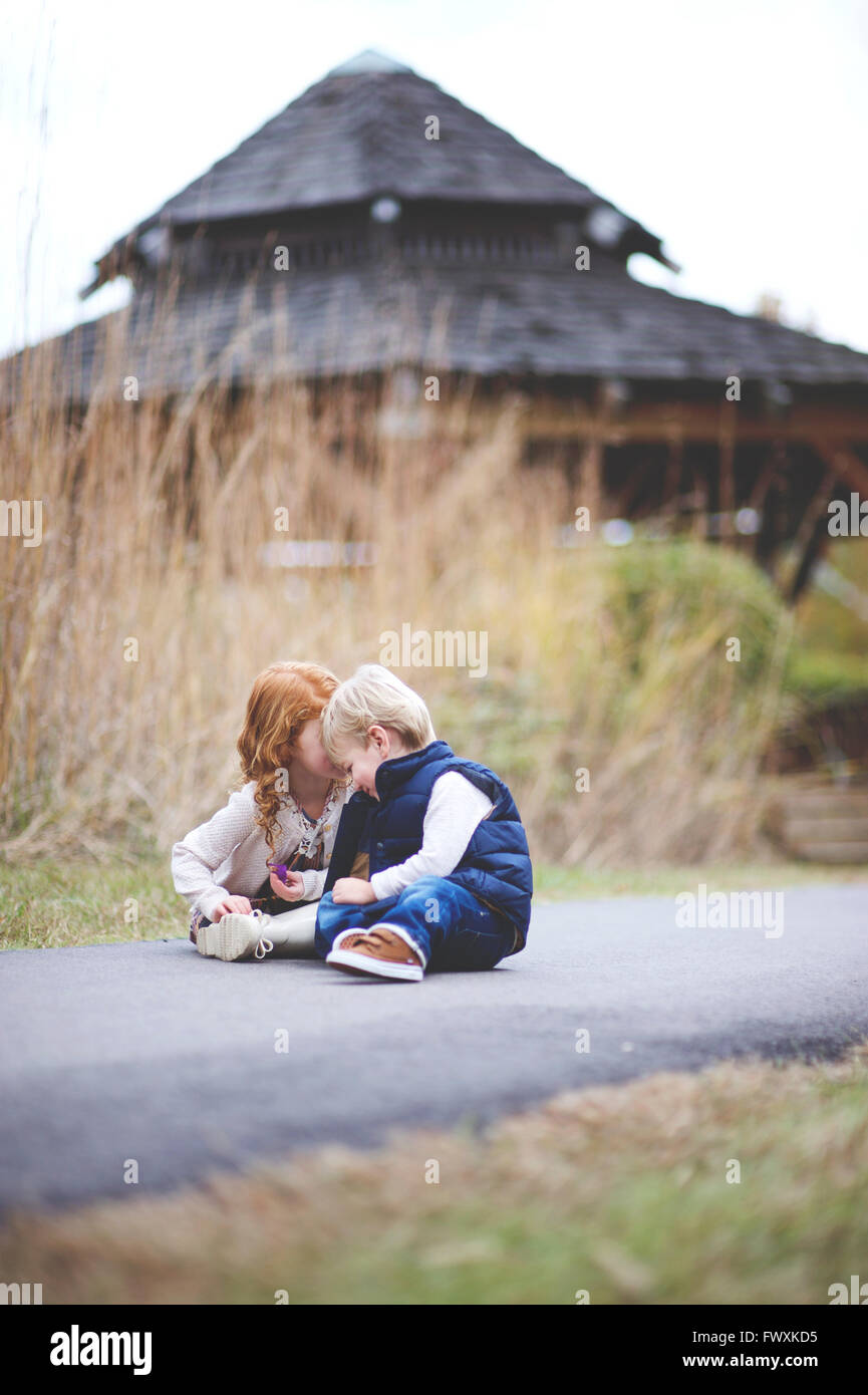 Brother and sister at the park sharing a moment Stock Photo - Alamy