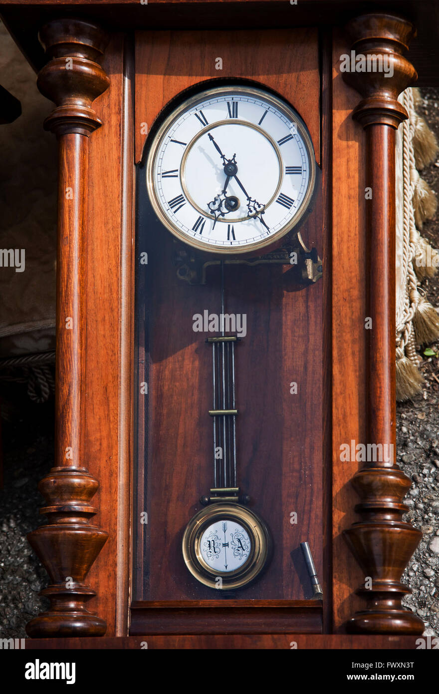 Vintage clock with beautiful hands and pendulum with monograms on display  at flea market Stock Photo - Alamy