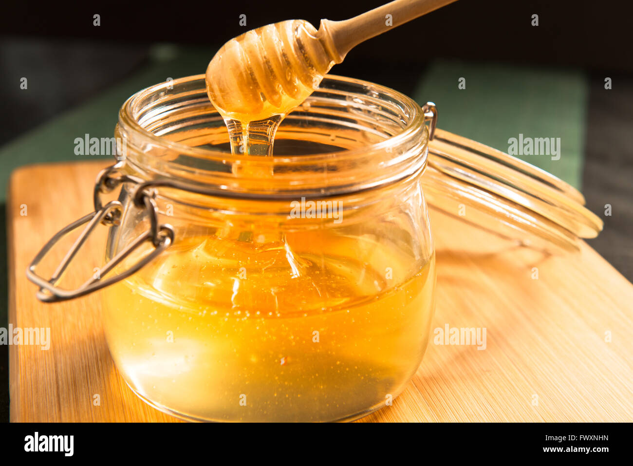 Acacia honey in a jar with honey stick Stock Photo Alamy