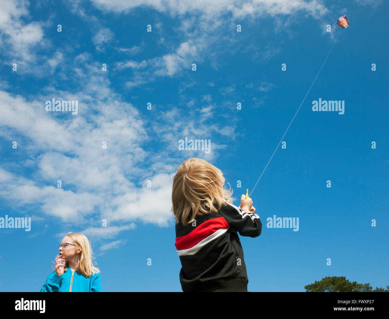 Sweden, Skane, Nyhamnslage, Two sisters (6-7, 10-11) flying kite Stock Photo