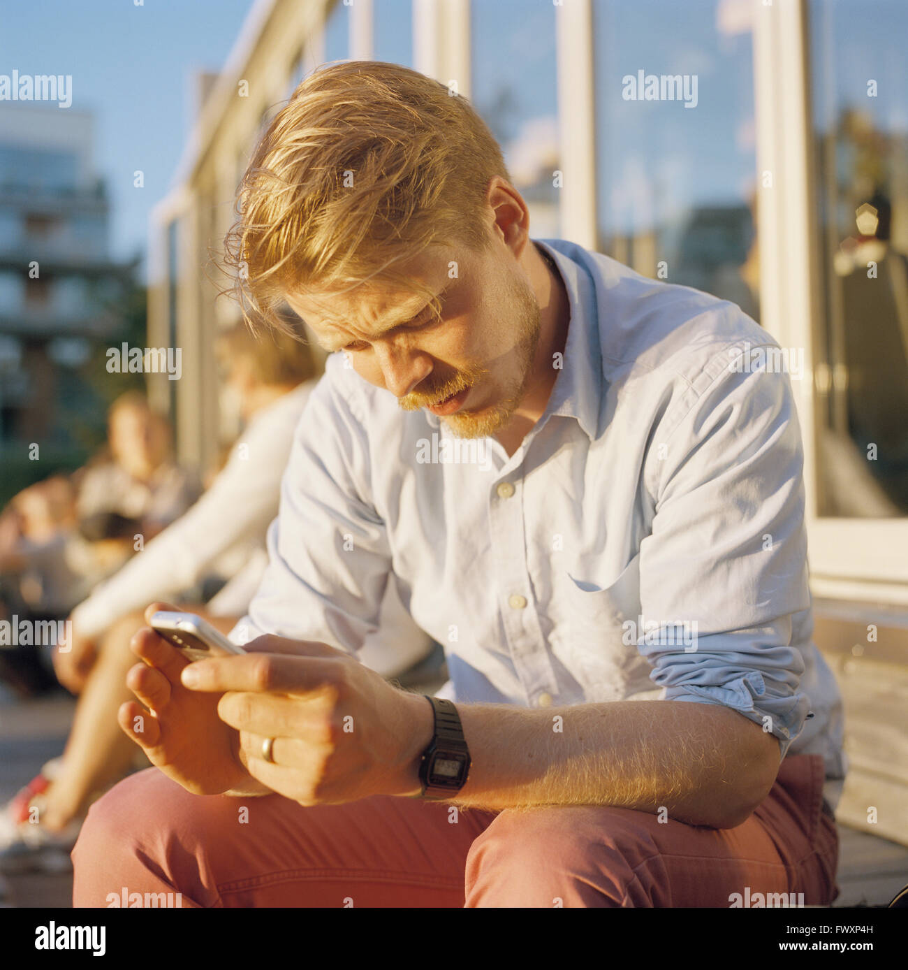Sweden, Stockholm, Mid adult man using mobile phone Stock Photo