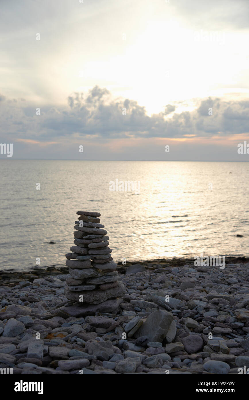 Sweden, Oland, Stack of pebbles on beach Stock Photo