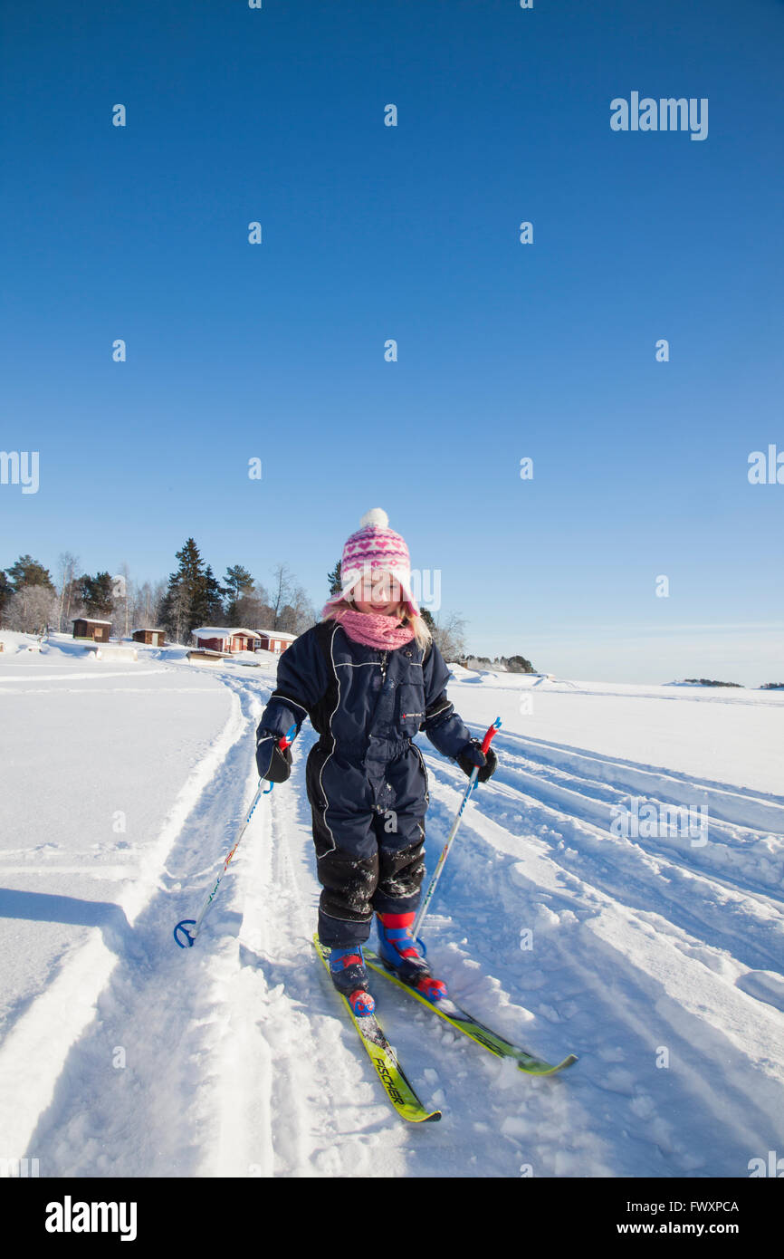 Sweden, Medelpad, Juniskar, Girl (6-7) learning how to ski Stock Photo