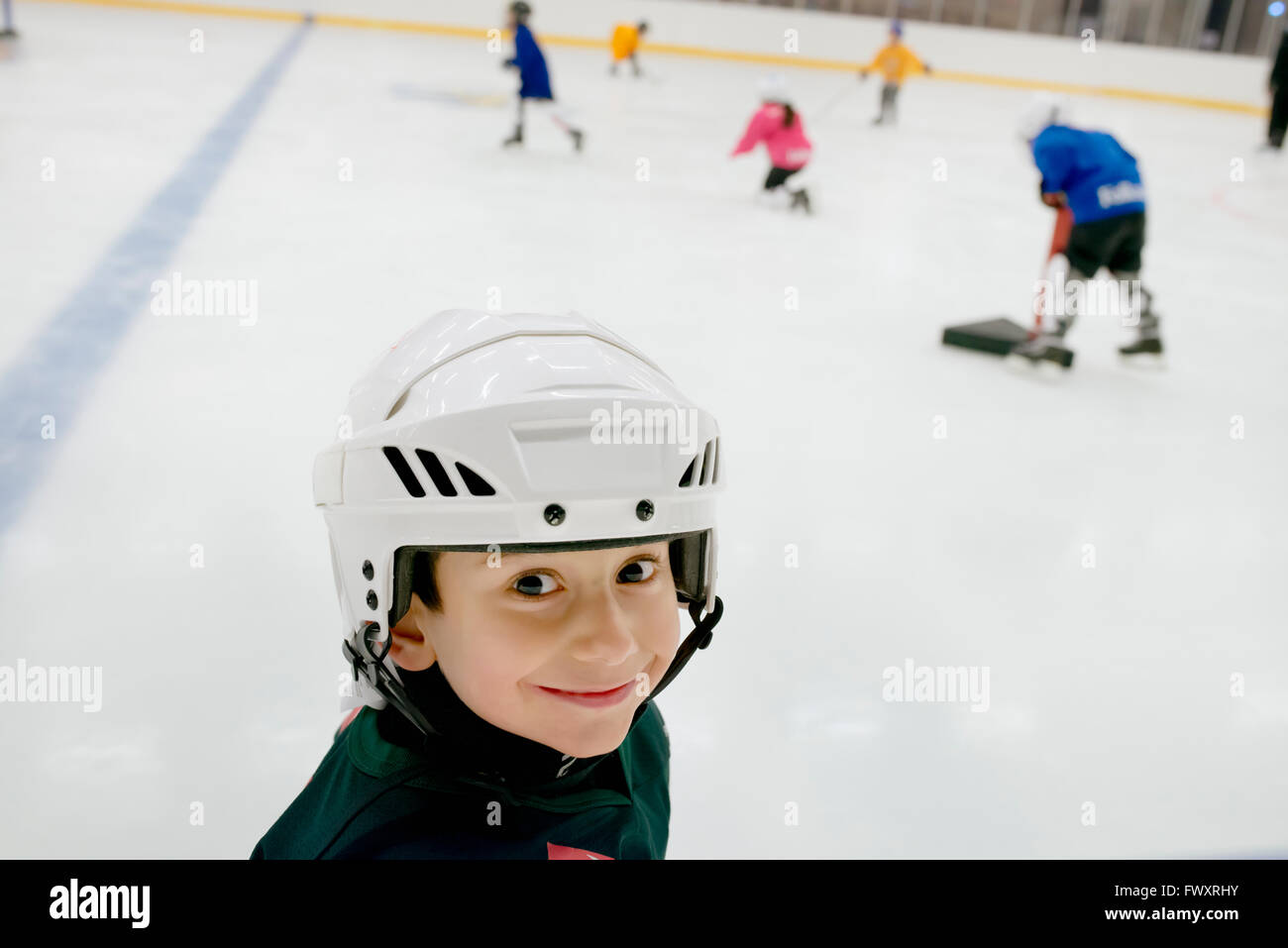 Sweden, Portrait of young male hockey player (4-5) on ice Stock Photo