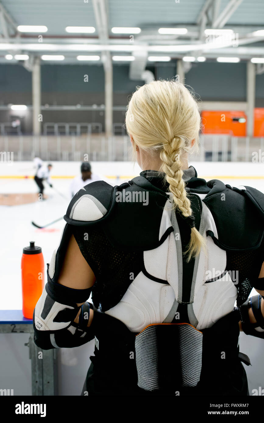 Sweden, Young ice hockey player standing by ice rink Stock Photo Alamy