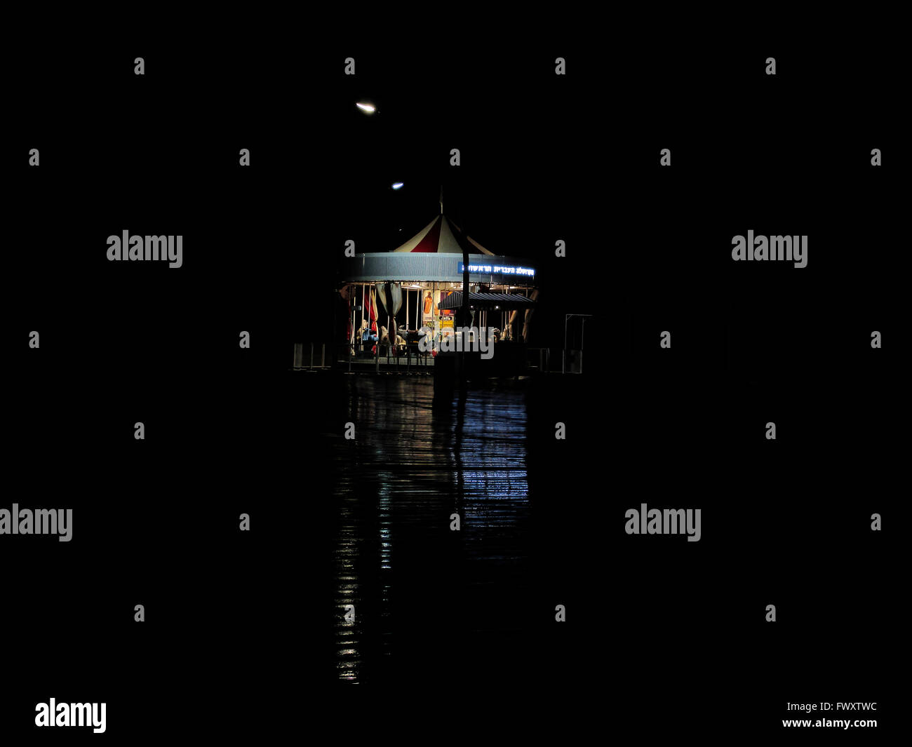 A carousel at night. Photographed at the old Tel Aviv Port, Israel Stock Photo