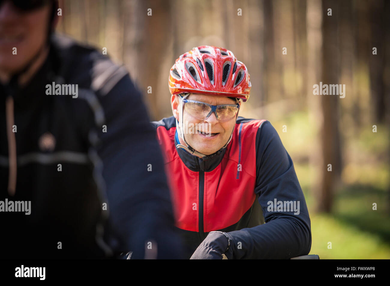 Sweden, Blekinge, Solvesborg, Ryssberget, Mature men in cycling helmets forest Stock Photo