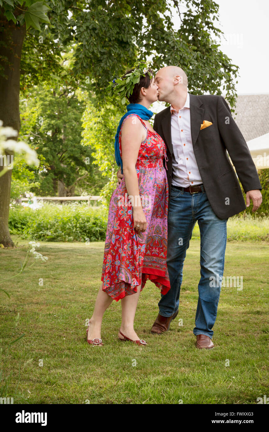 Sweden, Skane, Couple kissing during midsummer celebrations Stock Photo