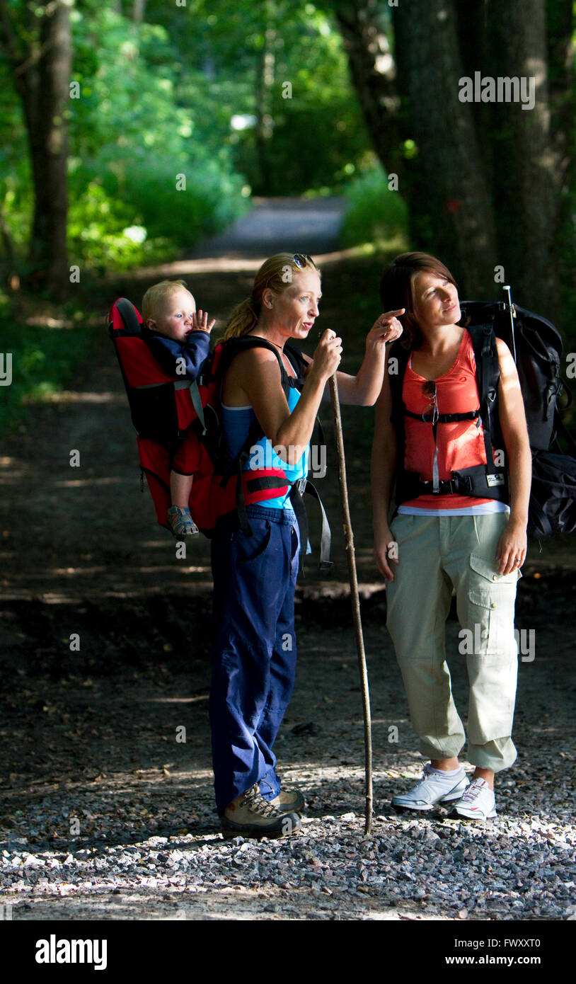 Sweden, Ostergotland, Agelsjon, Two women hiking in forest with baby boy (2-3) Stock Photo