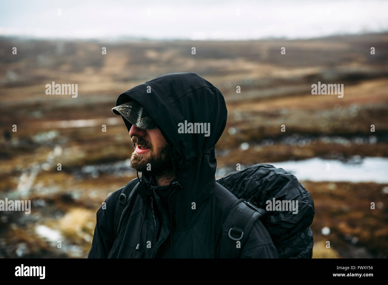 Sweden, Sylama, Jamtland, Portrait of backpacker in hooded jacket Stock Photo
