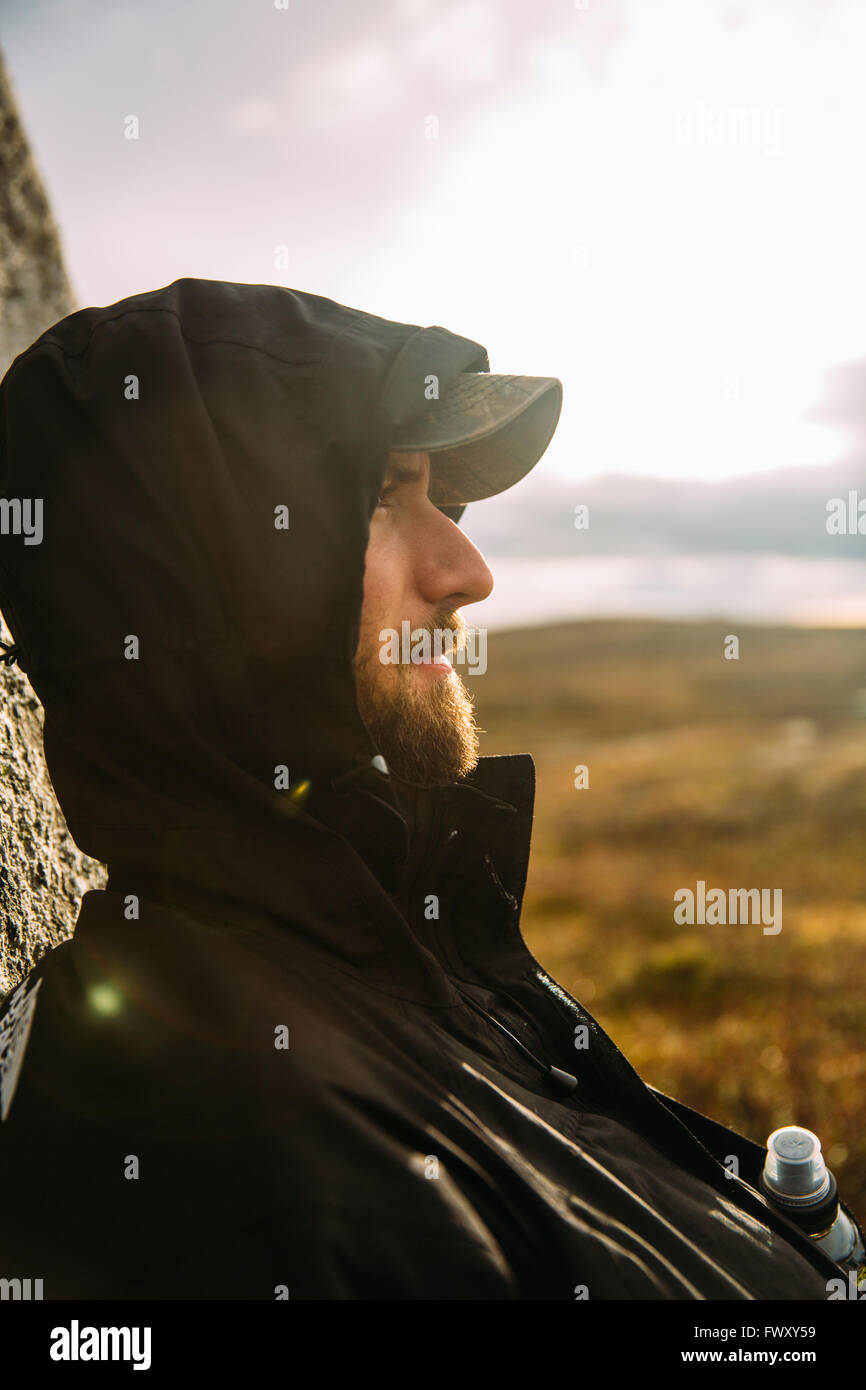 Sweden, Sylama, Jamtland, Portrait of young man in baseball cap and hood Stock Photo