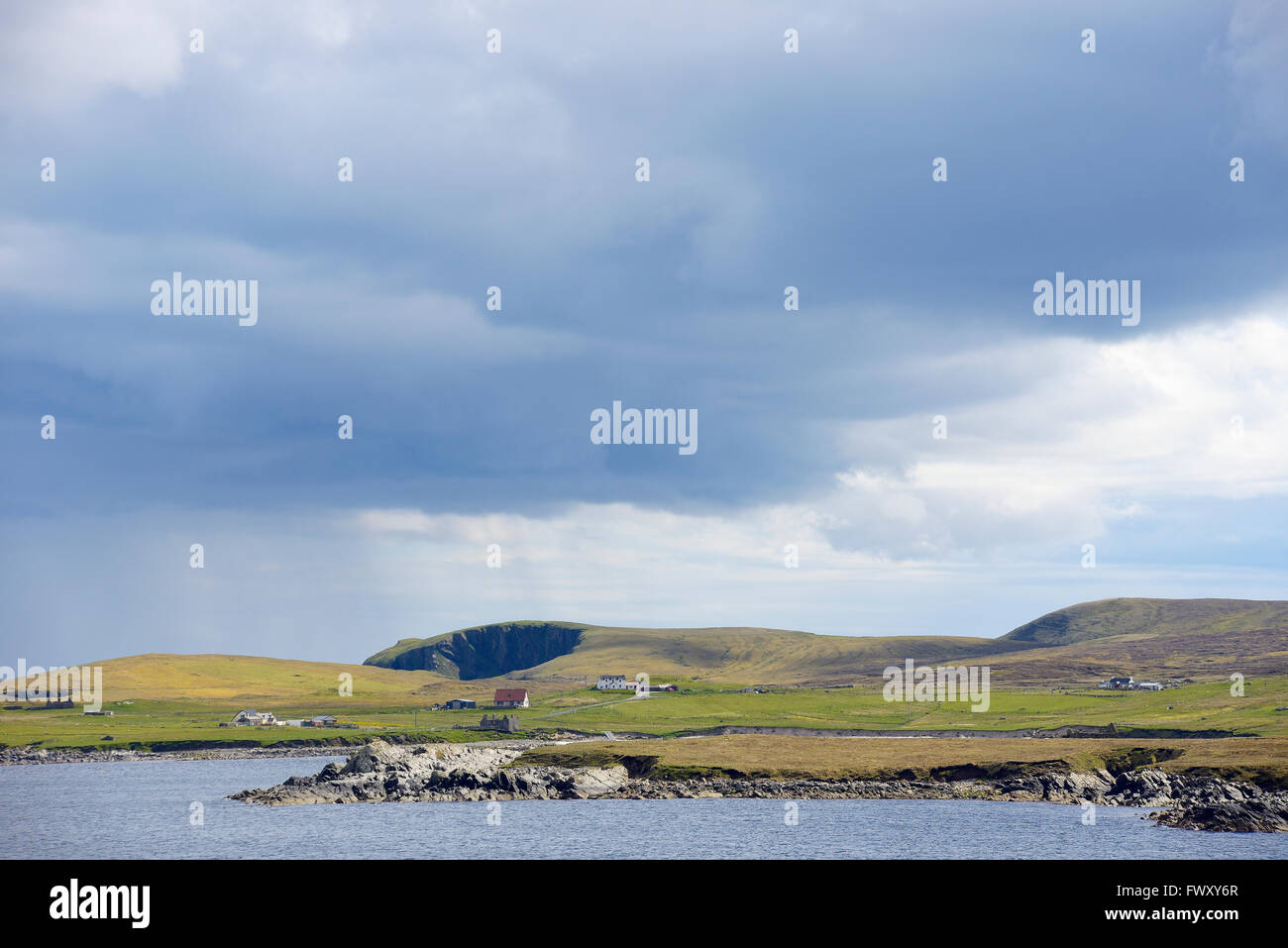 UK, Scotland, Shetland, Yell, Otterswick, Grass plateau by sea Stock Photo