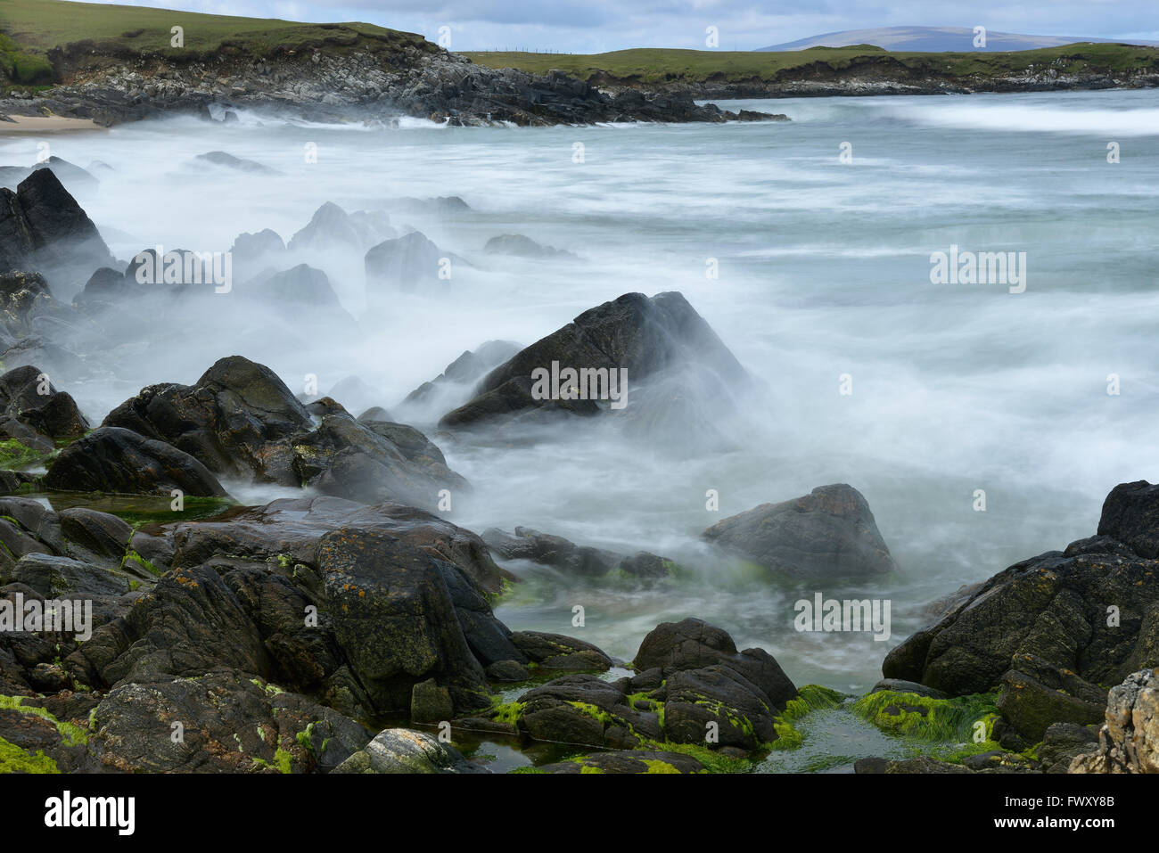 UK, Scotland, Shetland, Yell, Waves breaking on rocks Stock Photo