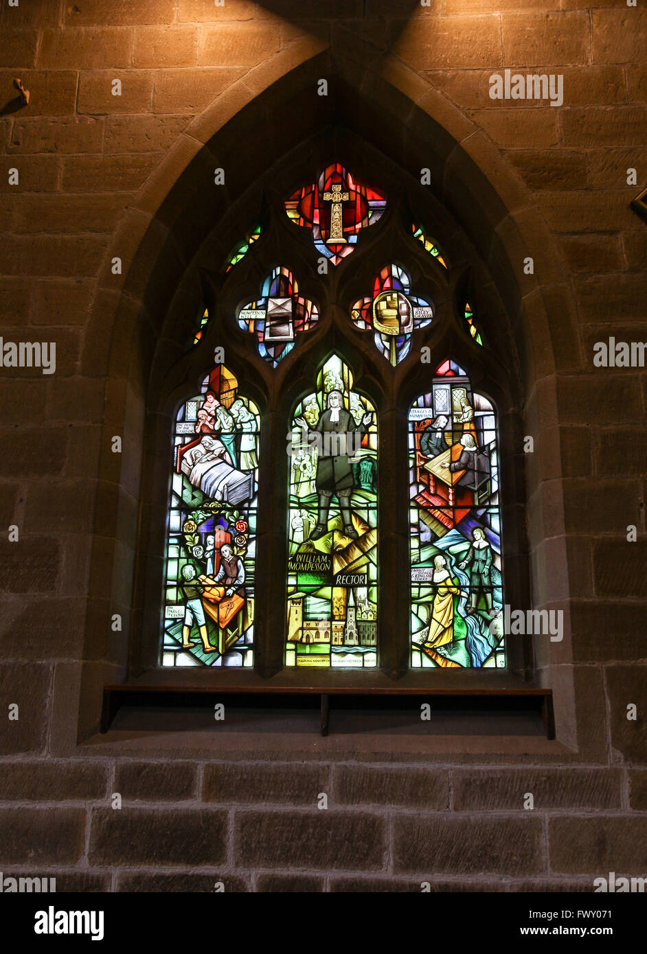 Stained glass window depicting the story of the plague in St Lawrence’s parish Church Eyam Derbyshire England UK Stock Photo