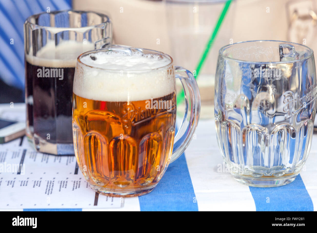 Glass of Czech beer Pilsner Urquell beer in original glasses on a desk, Prague bar, Czech Republic Stock Photo