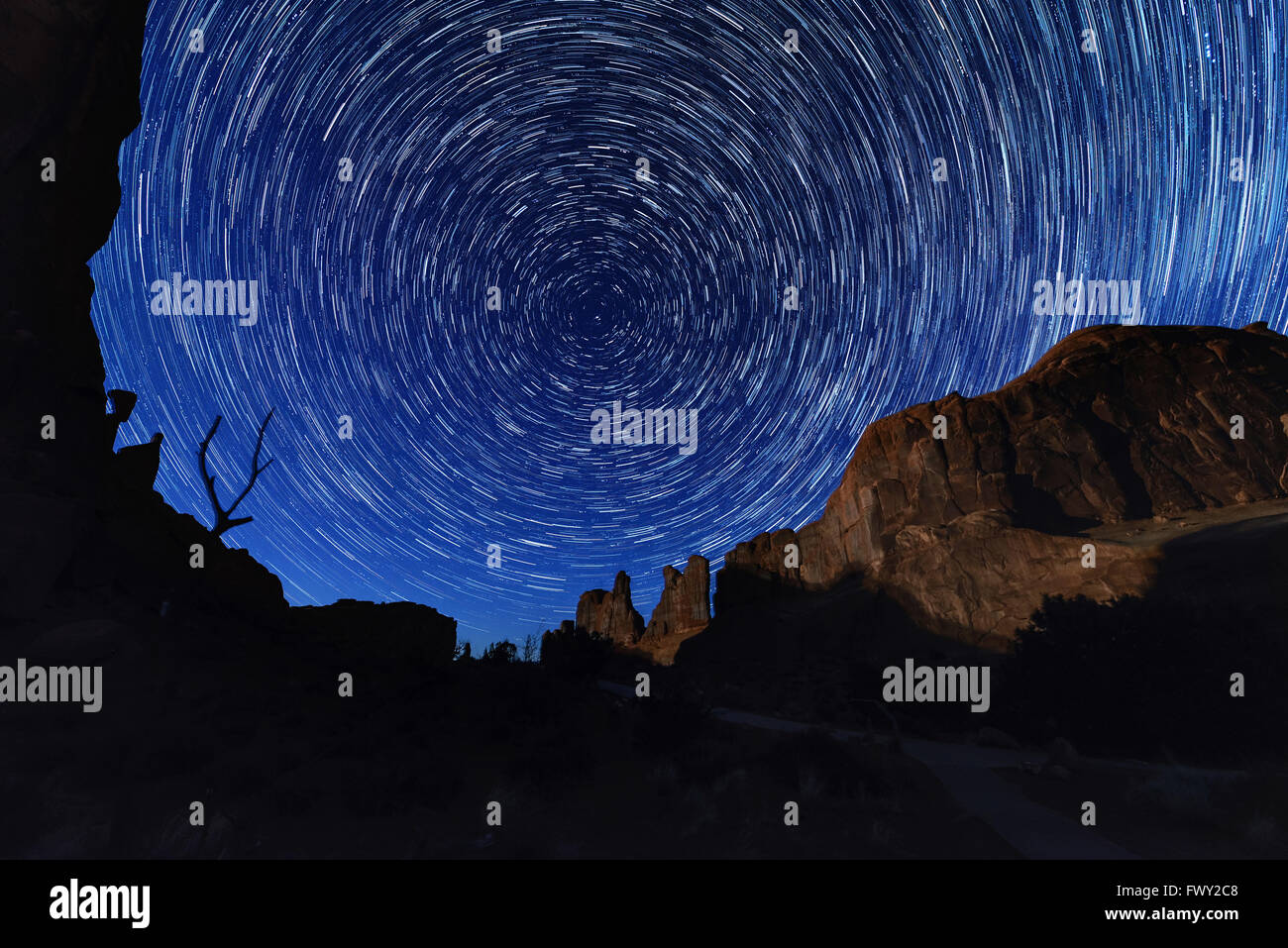 Circle light of star trails at Arches National park, Utah USA, huge rock as a fore ground Stock Photo
