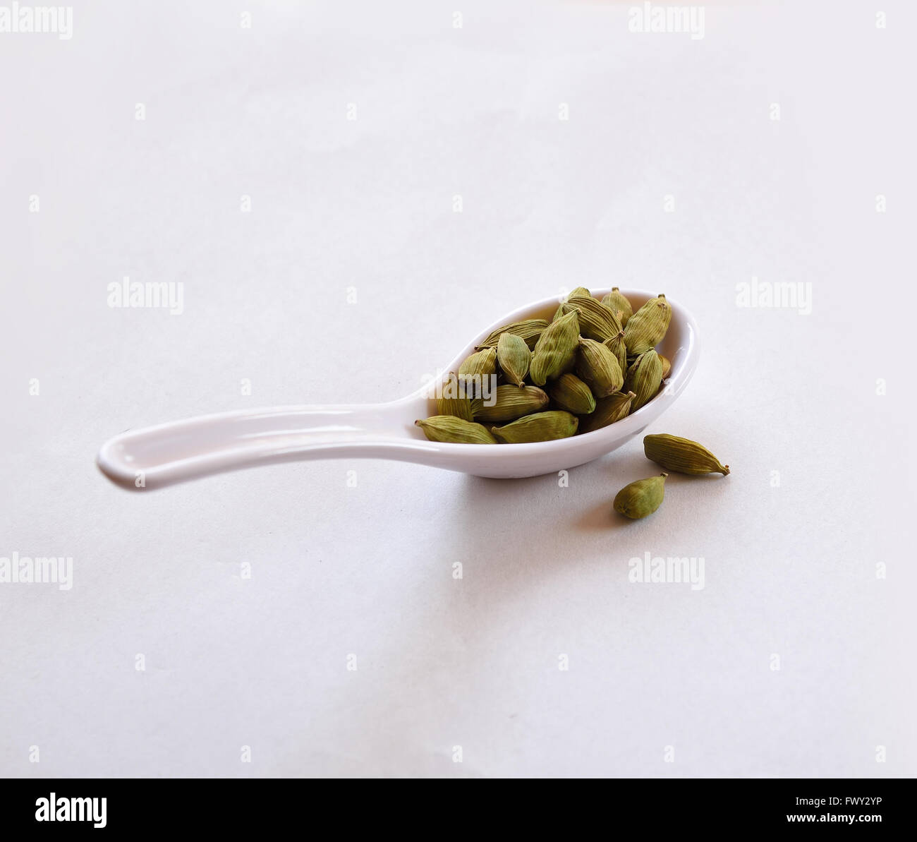 Cardamom in a white spoon Stock Photo