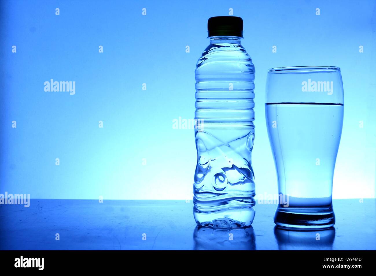 Bottled drinking water and a glass of water Stock Photo Alamy