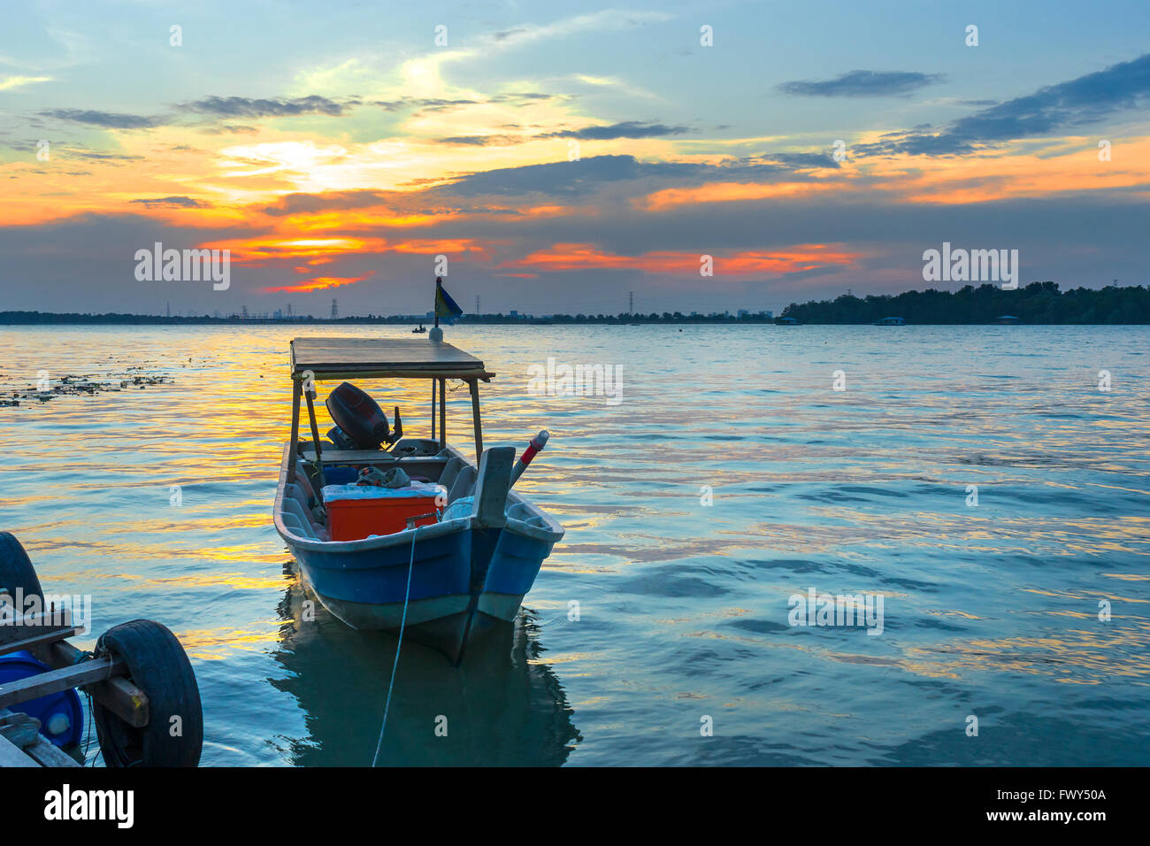 Wooden fisherman boat with sunset background Stock Photo - Alamy
