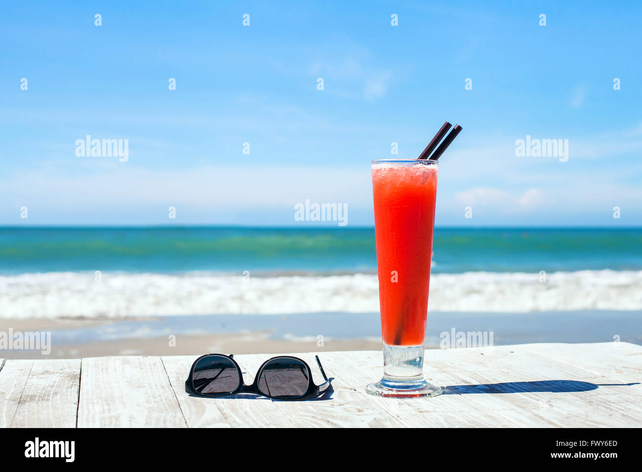 tropical vacations, background with cocktail and sunglasses on the beach Stock Photo