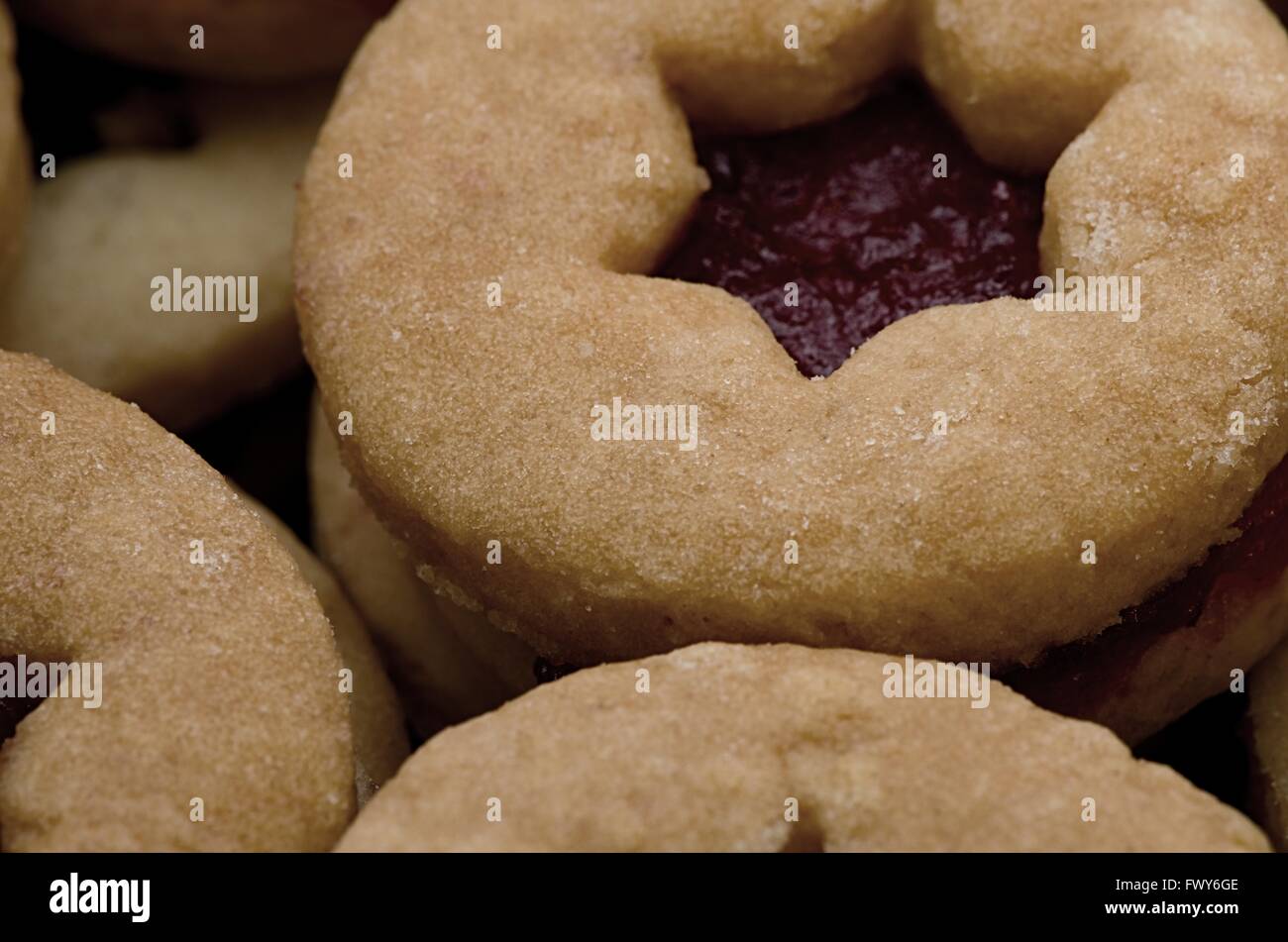 Round cookies with red jam in starshaped hole Stock Photo Alamy