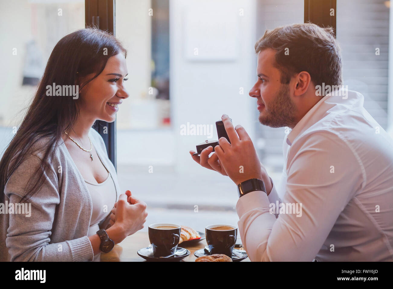 proposal, engagement concept, happy couple in restaurant, man offers