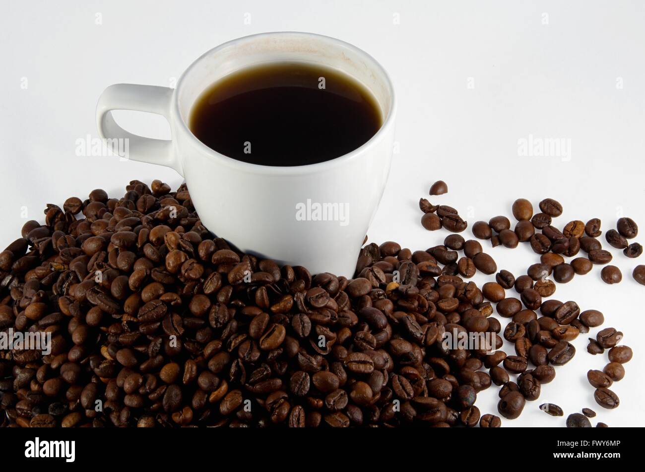 White cup with coffee and trowel of coffee beans Stock Photo