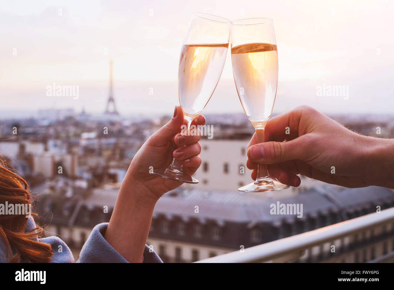 two glasses of champagne or wine, couple in Paris, romantic celebration of engagement or anniversary Stock Photo