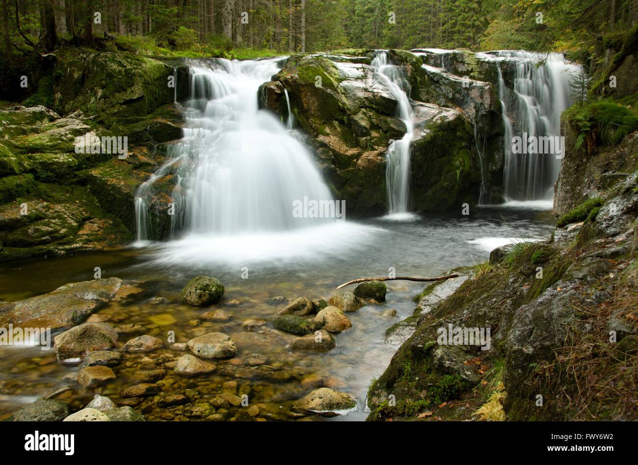 Amazing waterfalls in a wooded mountainous landscape Stock Photo - Alamy